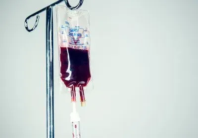 Human blood in a plastic Intravenous drip bag, the tube running out of the image. Square crop. Horizontal with copy space.